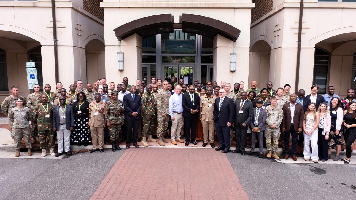 A group photo of UNC-Chapel Hill faculty and leaders along with dignitaries from Malawi, Zambia and Botswana in front of the Bioinformatics Building on the campus of UNC-Chapel Hill.