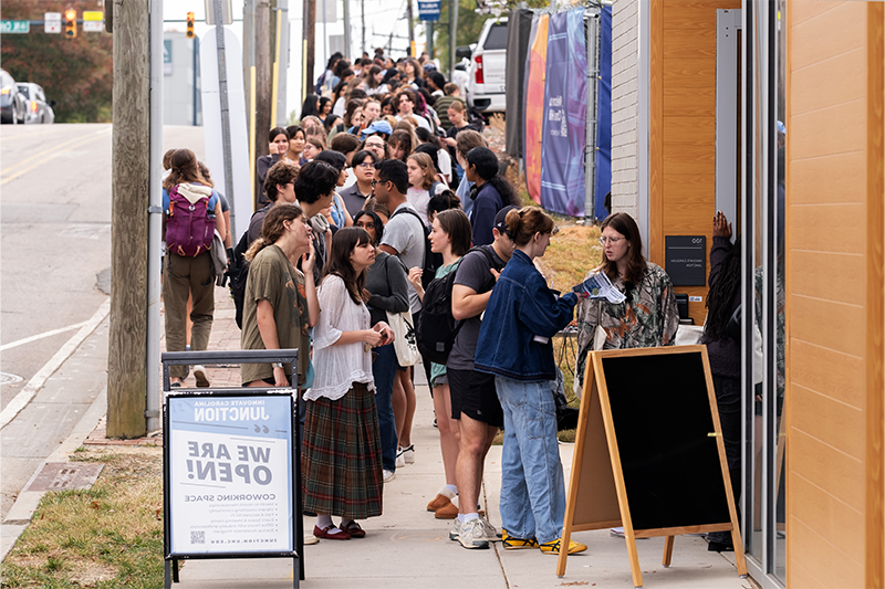 Long line of students extending down the sidewalk on Rosemary Street. The students were waiting for the opening of Meantime Coffee's location at the Junction.